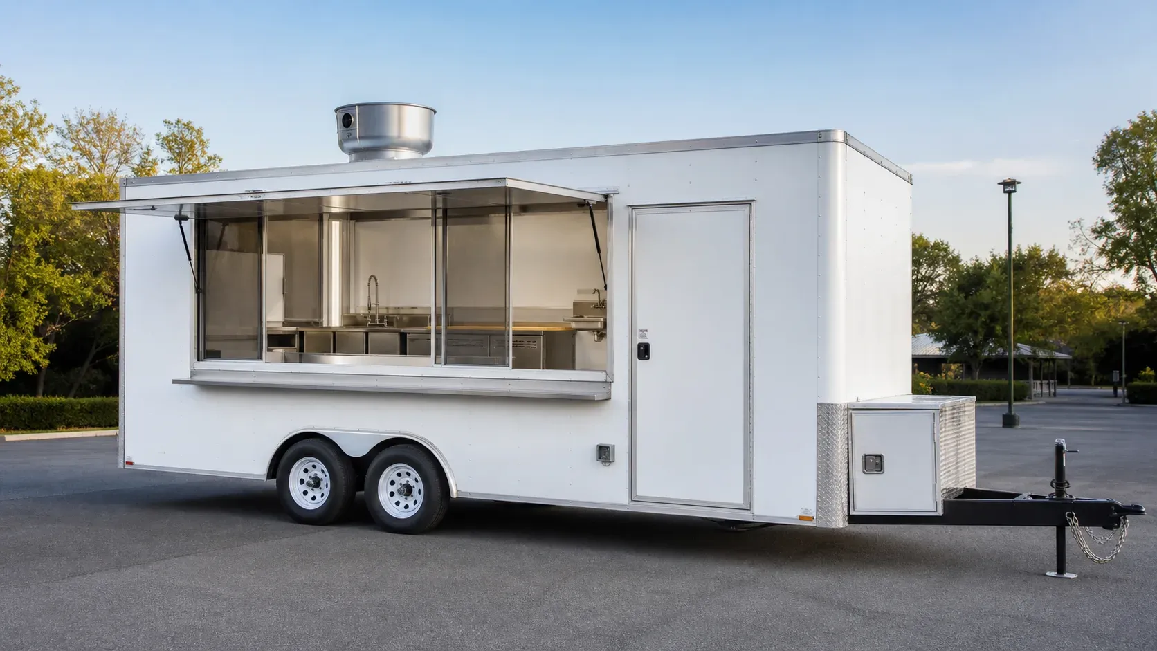 Tandem-axle concession trailer with an open serving window and stainless kitchen interior