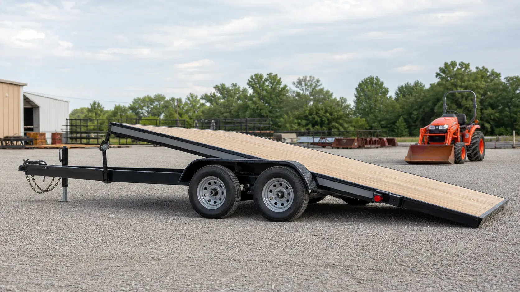 Tandem-axle gravity-tilt trailer lowered into loading position Tandem-axle gravity-tilt trailer lowered into loading position