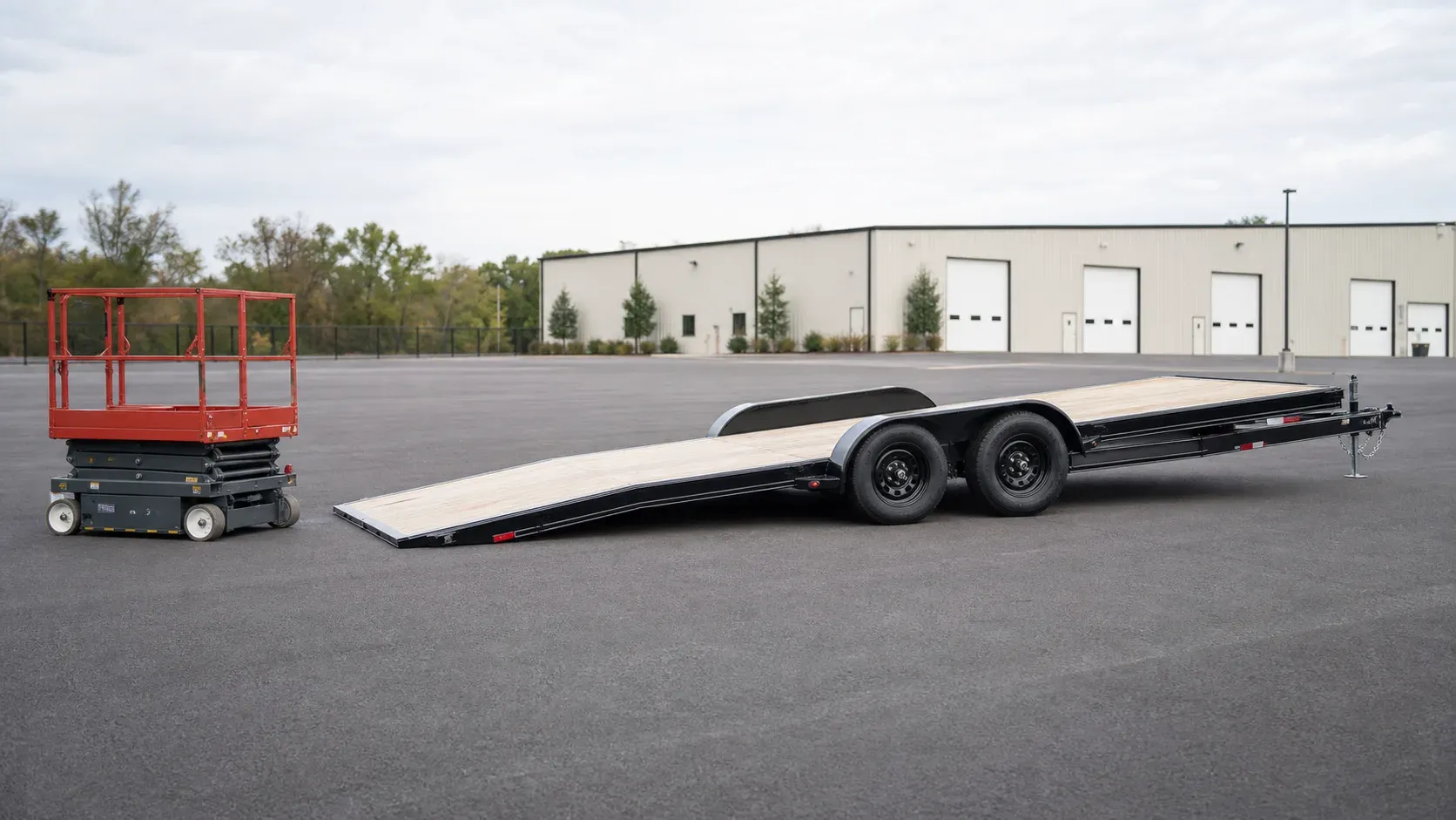 Low-profile tilt trailer demonstrating a shallow loading angle Low-profile tilt trailer demonstrating a shallow loading angle