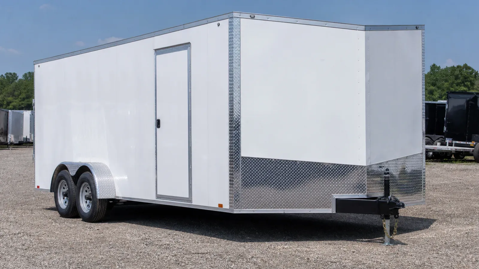 White V-nose enclosed cargo trailer viewed from the front corner White V-nose enclosed cargo trailer viewed from the front corner